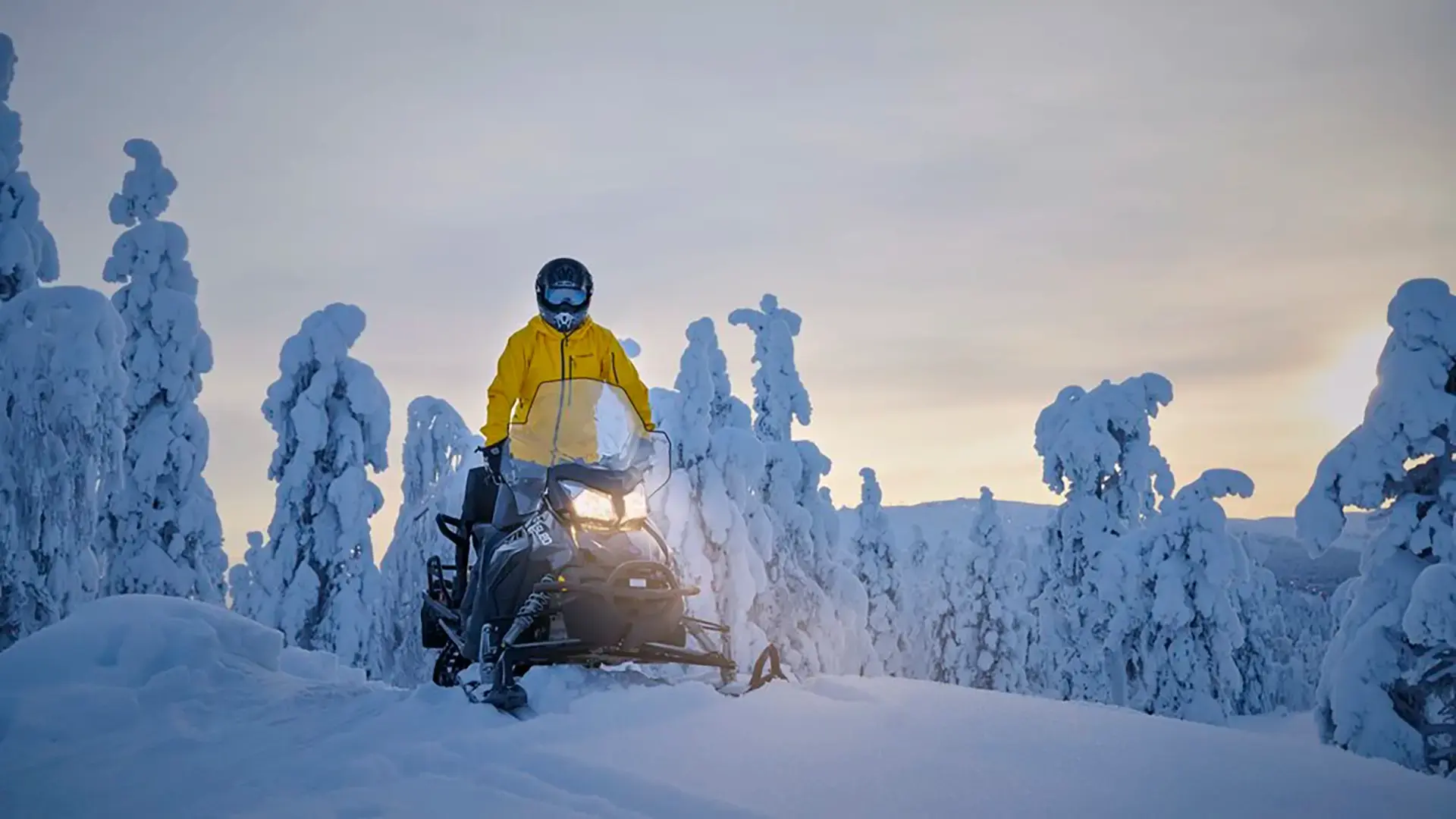man-on-electric-snowmobile-in-winter-landscape