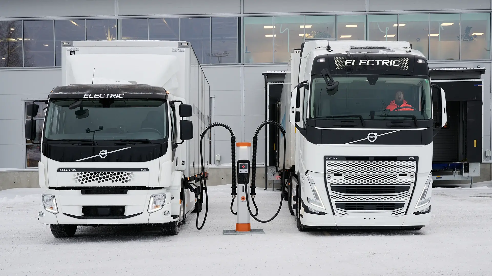 Zwei elektrische Lkw werden an einer Schnellladestation an einem Depot geladen