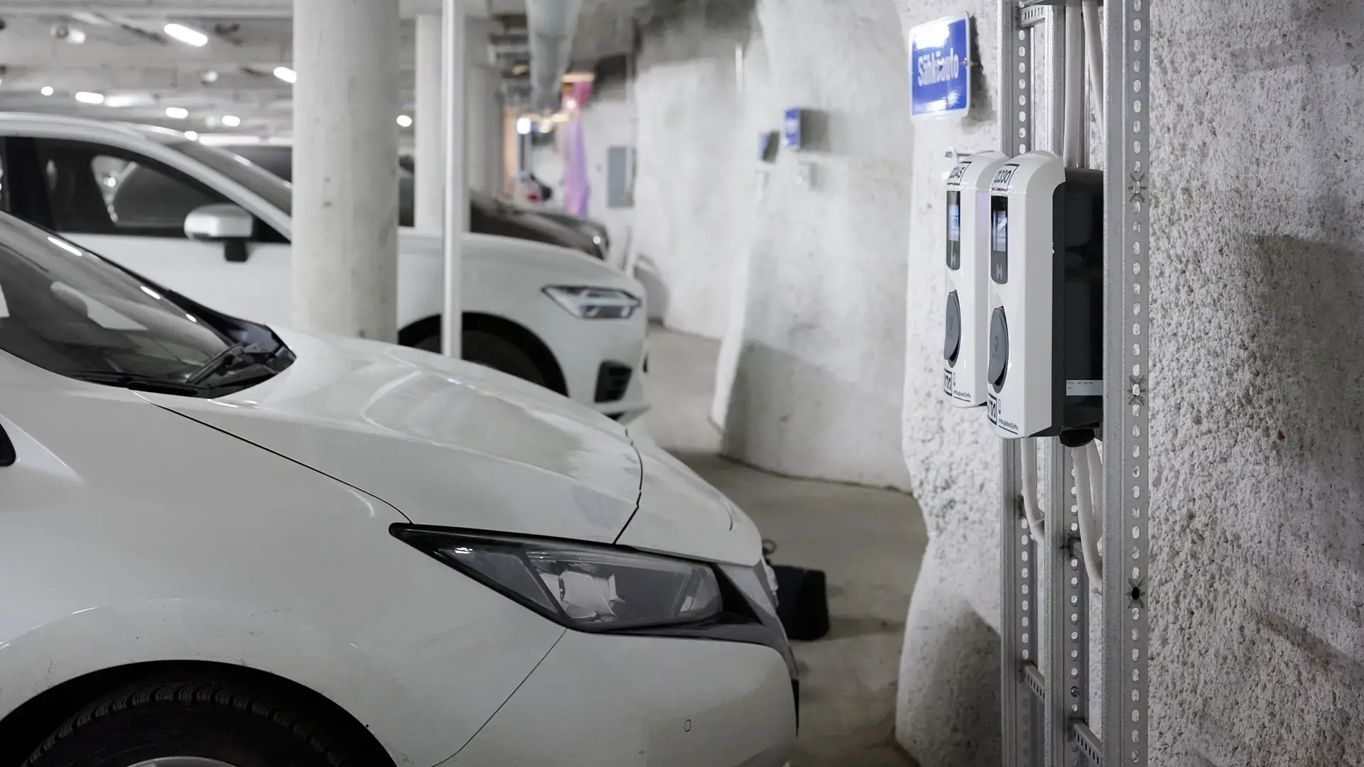 Rokkiparkki car next to two AC chargers in underground parking lot