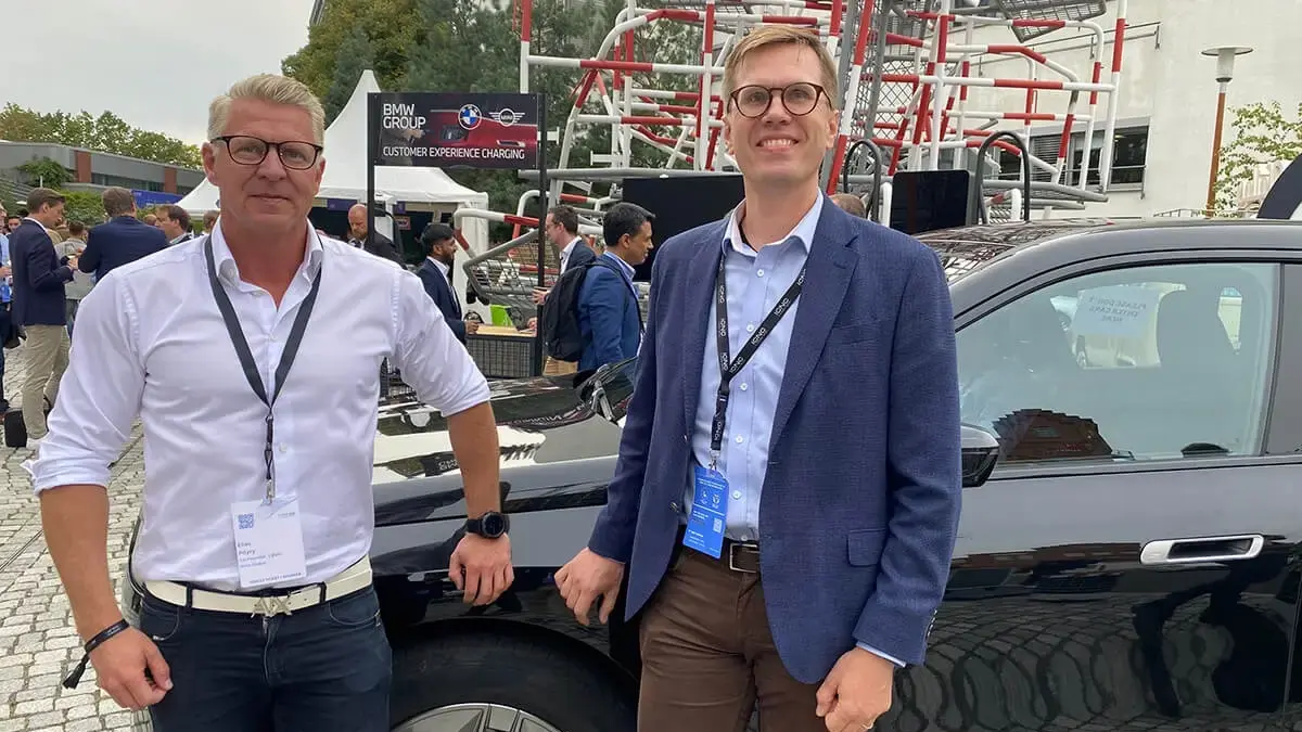 Elias Pöyry and Jussi Ahtikari at ICNC in front of a BMW EV