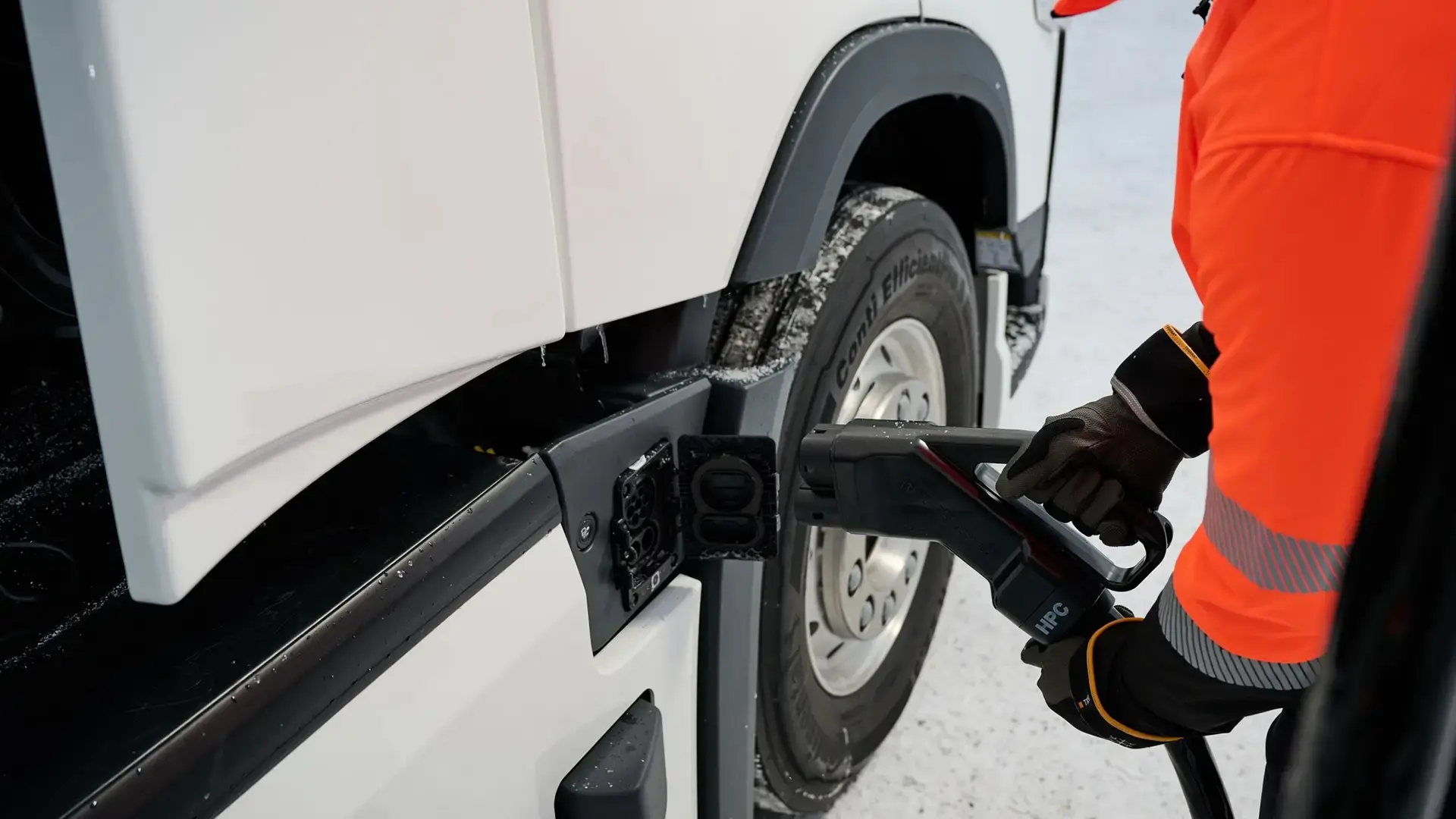 Man charging electric truck with CCS charging connector
