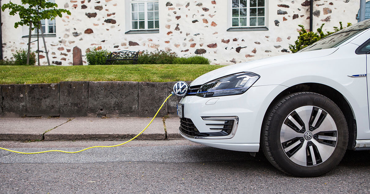 une voiture blanche qui se recharge dans la rue